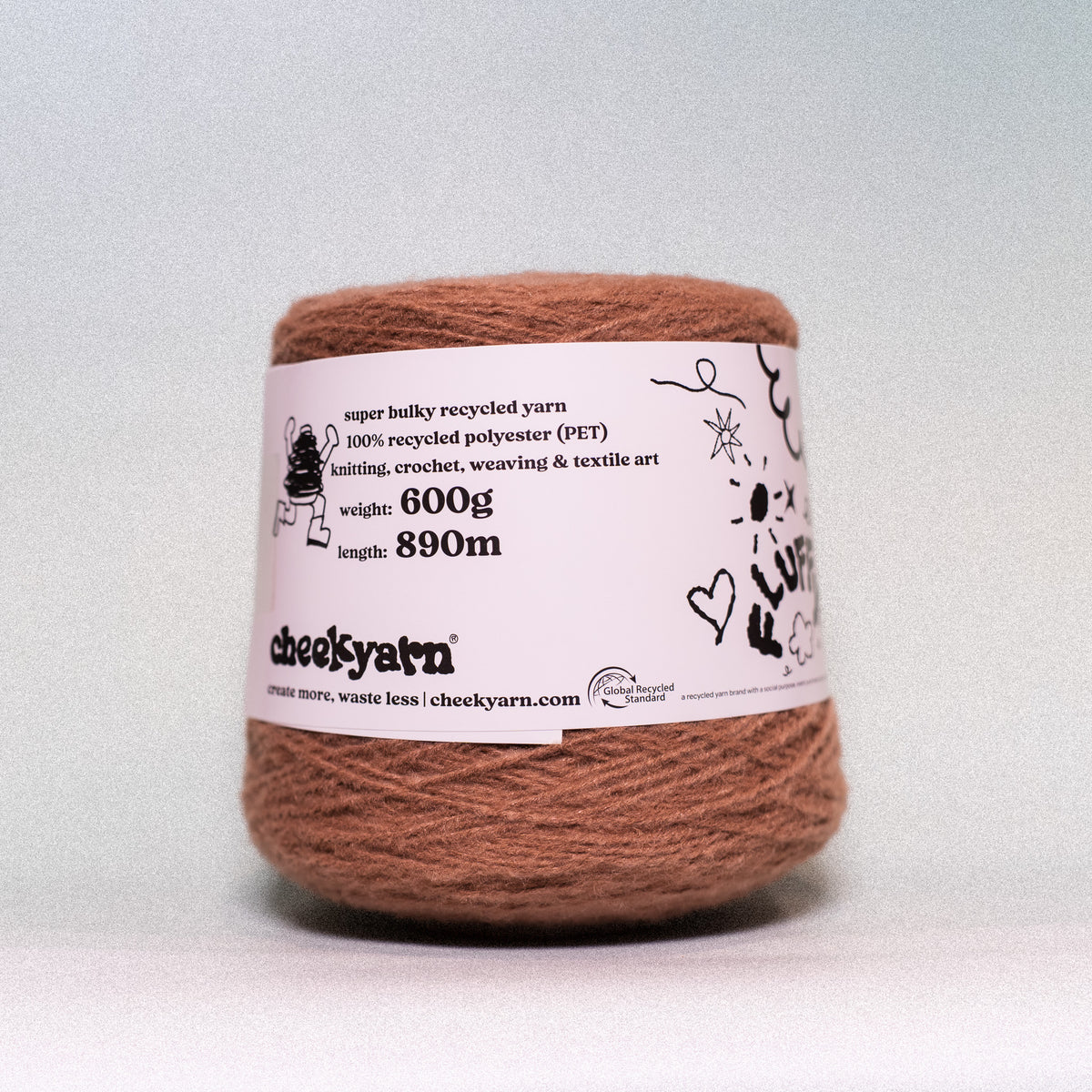 A single spool of brown recycled polyester yarn with a white paper label, photographed against a neutral light gray background.