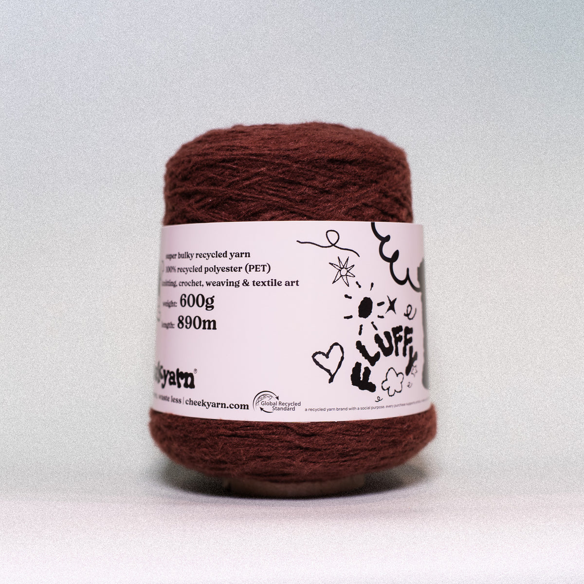 A spool of Cluff yarn in a dark reddish-brown color, featuring a white paper label with black hand-drawn style graphics and product details.