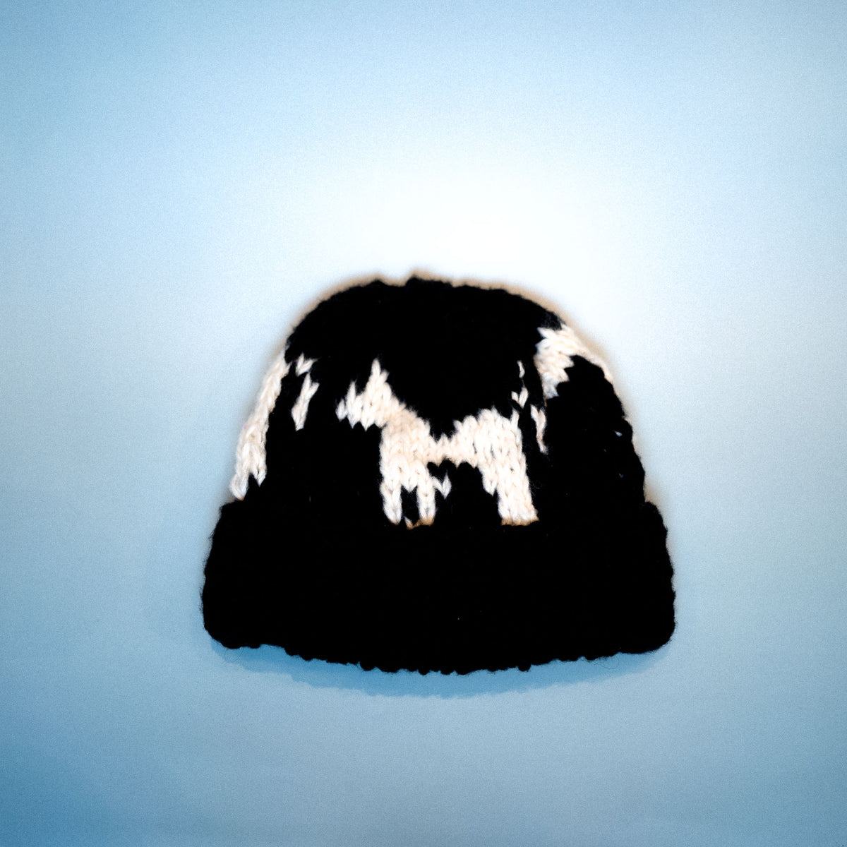 black ennis beanie with white horse motif